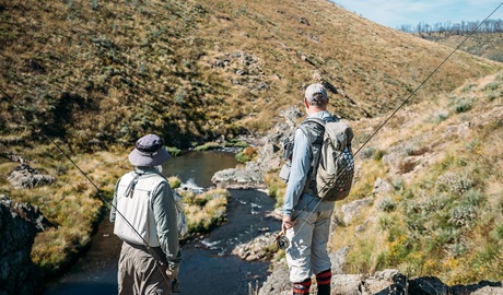 Two people checking out a fishing spot in the Snowy Mountains on a Snowy Valleys Fly Fishing tour. Photo © Jimmy Barwick