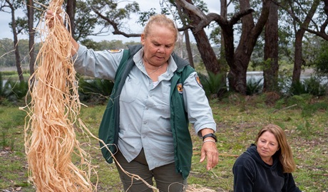 NPWS guide demonstrating some traditional Aboriginal weaving techniques, Beowa National Park. Photo: Jessica Taunton