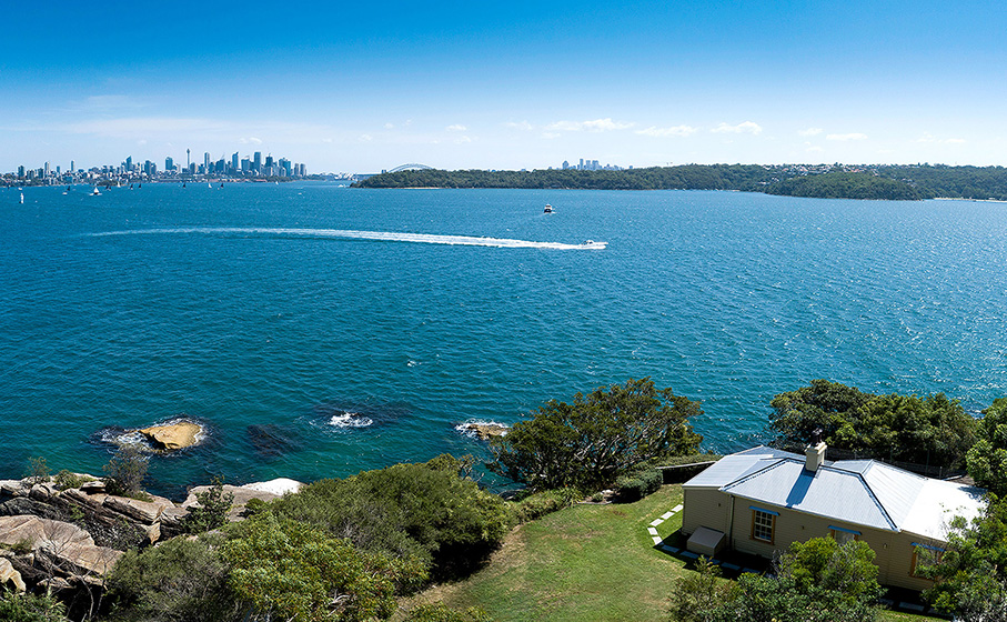 An aerial view of Steel Point Cottage with Sydney Harbour and Sydney City views in the background. Credit: Gareth Pickford © DCCEEW