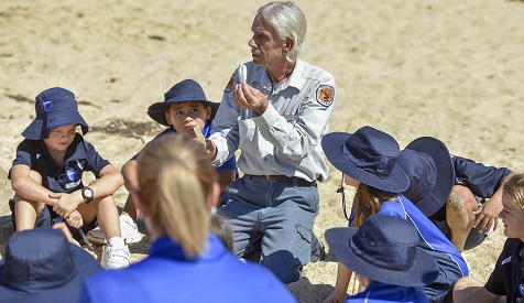 Aboriginal ranger Uncle Gary with junior students on the beach, Glenrock State Conservation Area, 2019. Photo: Adam Hollingworth: Hired Gun © DPIE