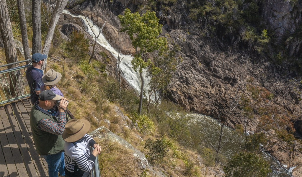 People looking out over Boonoo Boonoo Falls on the Falls Lookout walk in Boonoo Boonoo National Park. Photo: Joshua Smith &copy; DCCEEW