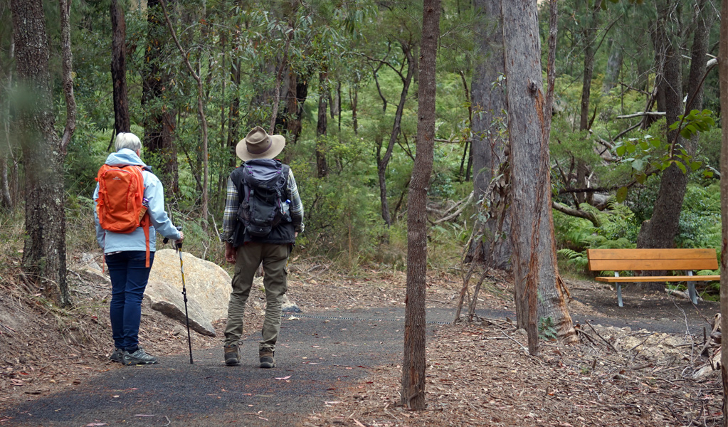 People approaching a seat on Rockpools View walk, Boonoo Boonoo National Park near Tenterfield. Photo: Christopher Ghirardello, &copy; DCCEEW