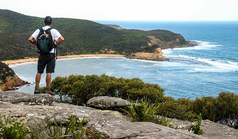 A person enjoying the view out to sea from the spur. Photo: John Yurasek &copy; OEH