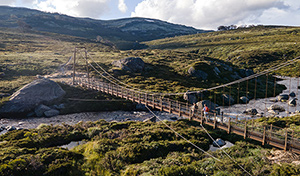 An aerial view of Spencers Creek Bridge along Guthega to Charlottes Pass walk in Kosciuszko National Park. Credit: Boen Ferguson © DCCEEW