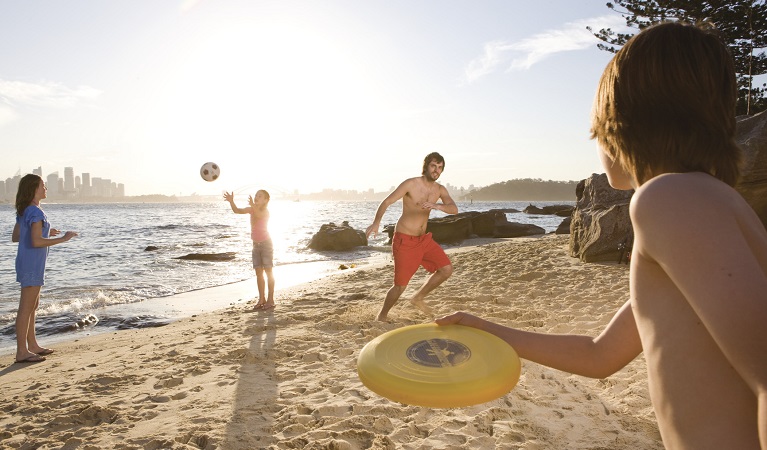 Throwing a frisbee on Shark Island – Boowambillee, Sydney Harbour National Park. Photo: Daniel Smith/OEH