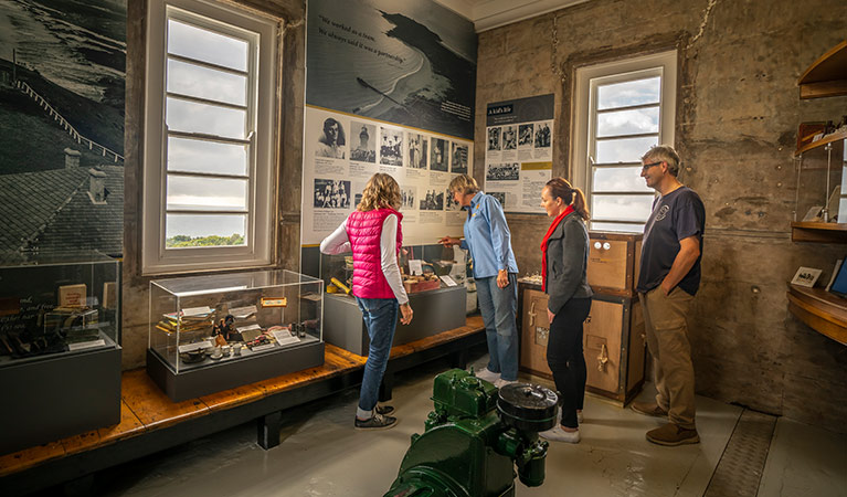 A tour group look at history displays in Cape Byron Lighthouse, Walgun Cape Byron State Conservation Area. Photo: John Spencer/OEH.
